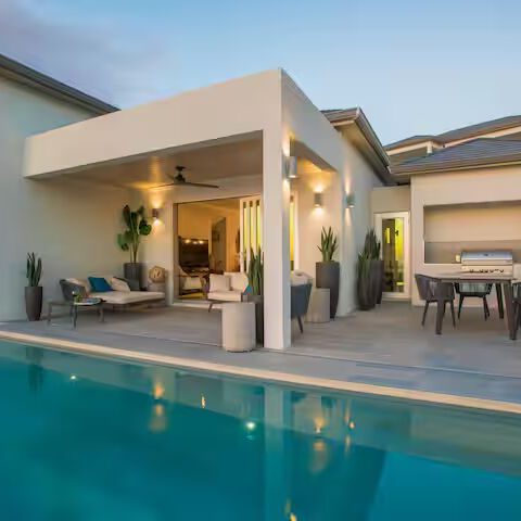 Modern villa with private pool at dusk